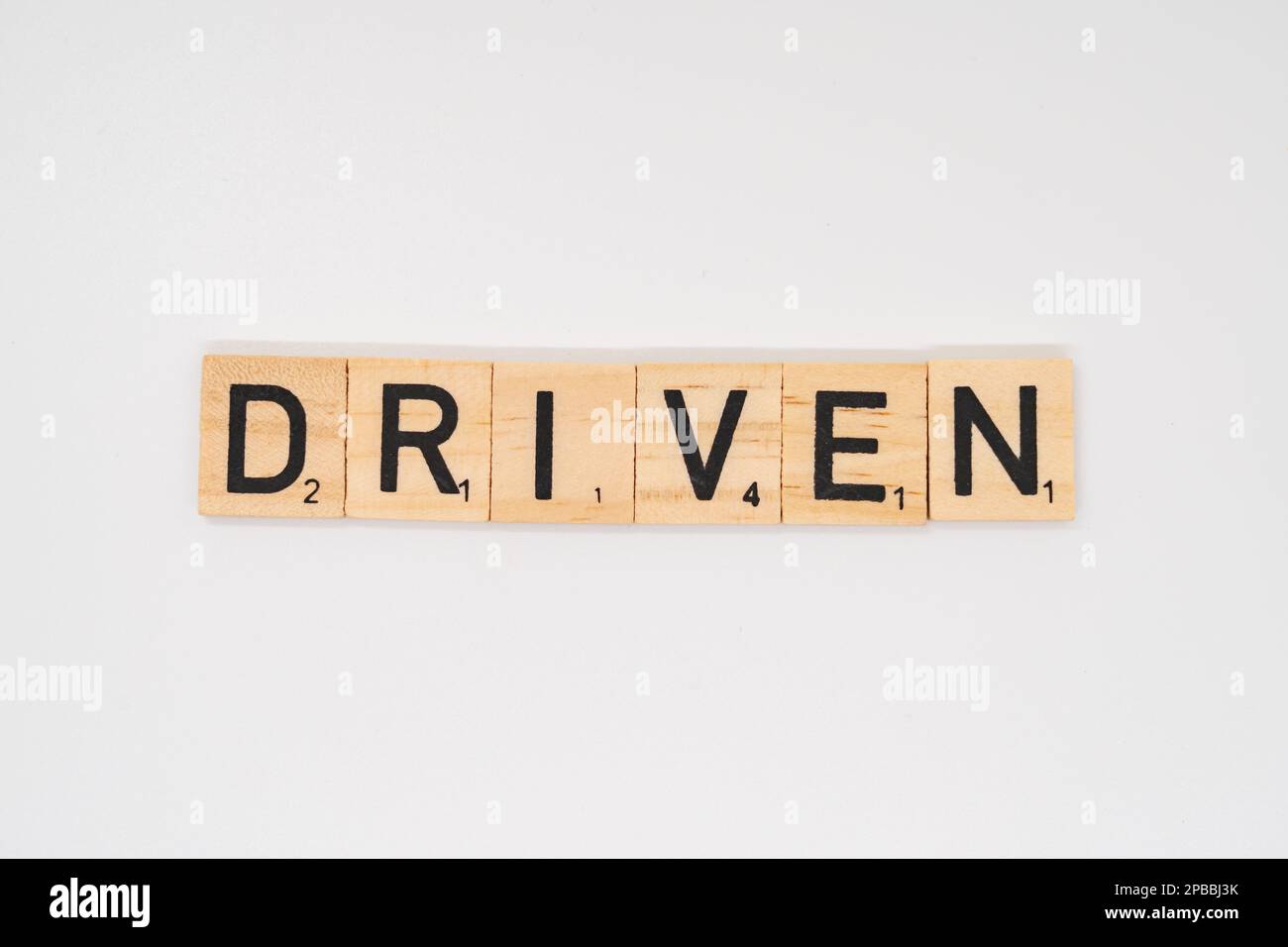 Wooden title spelling the word driven isolated on a white background Stock Photo