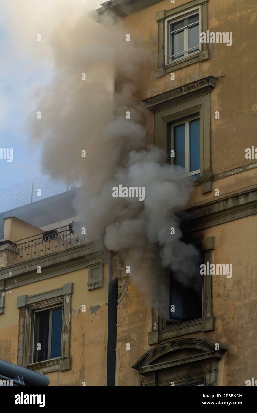 Domestic apartment fire with smoke billowing from window. Garibaldi Square, Naples, Italy, portrait Stock Photo