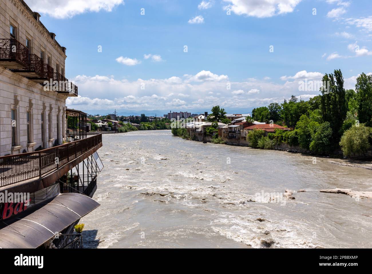 Kutaisi, Georgia, 04.06.21. Rioni river in Kutaisi, landscape view with white stones and traditional buildings on the river bank. Stock Photo