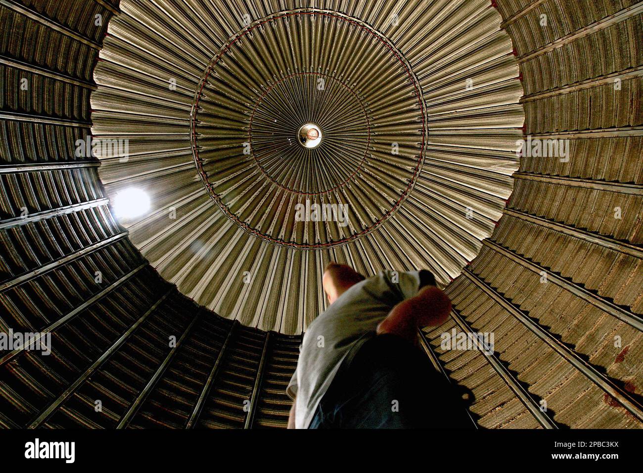 David Knott, 31, stands inside an empty grain bin on June 14, 2007, at grain elevator in