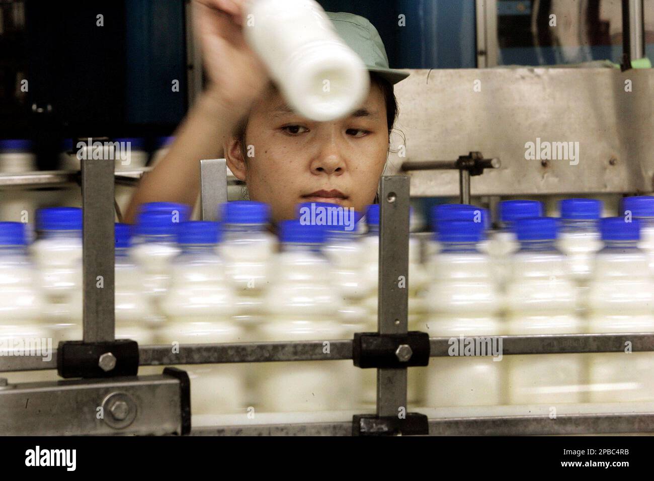 A worker selects products at the production line of Wahaha Tuesday July ...