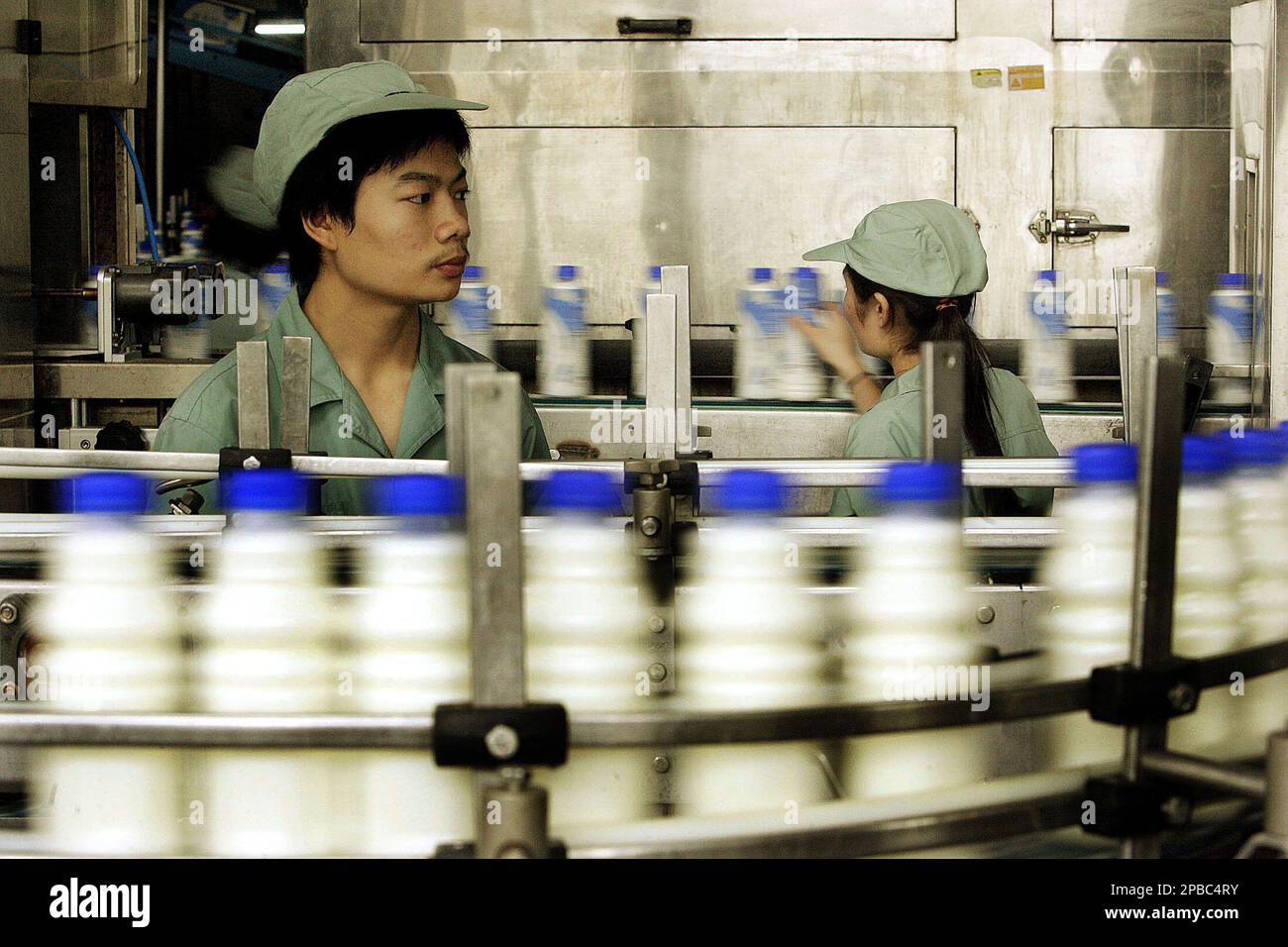 Workers select products at the production line of Wahaha Tuesday July 3 ...