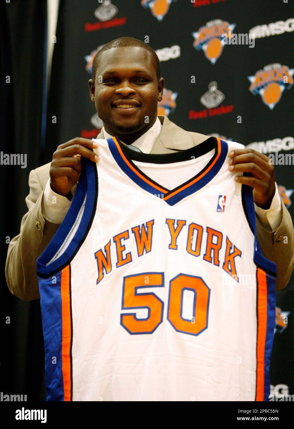 Newly-signed forward Zach Randolph holds his new jersey at Newly-signed forward Zach Randolph holds his new jersey at