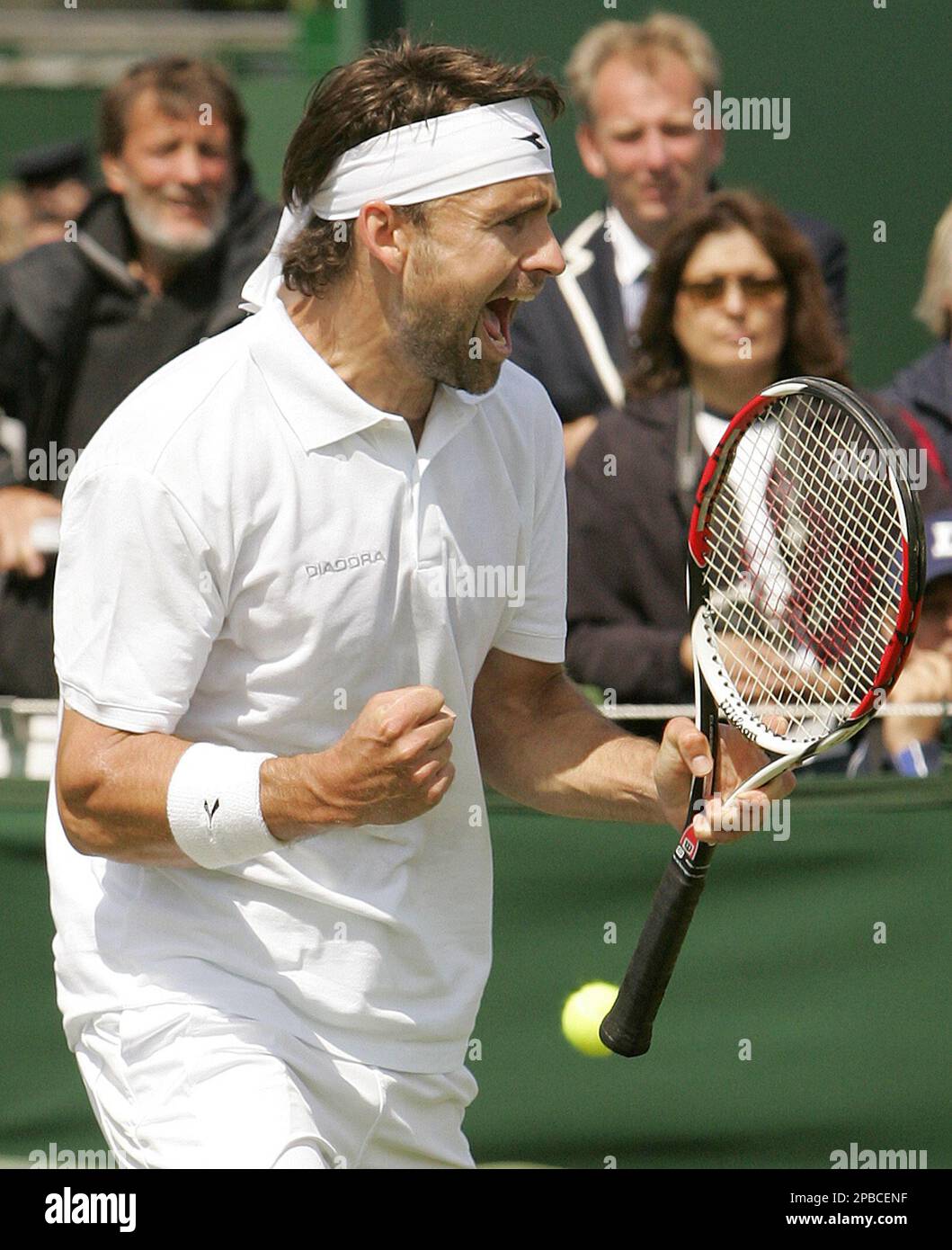 Germany's Nicolas Kiefer celebrates after beating Fabrice Santoro of