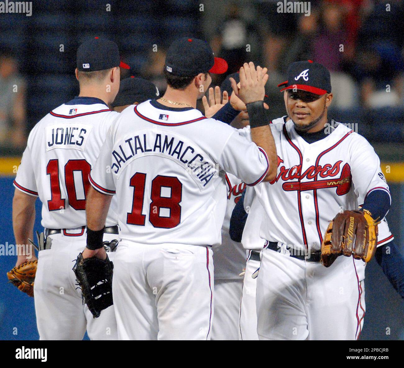 Atlanta Braves' Chipper Jones, right, celebrates with Braves Edgar