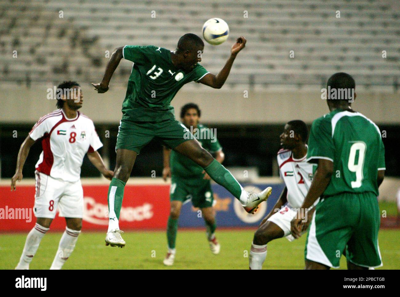 UAE's Haider Alo Ali, left, watches as Saudi Arabia's Almousa Ahmed Saddiq  E (13) goes for a header while his teammate Alhawsawi Malek Ali, right,  looks on during their friendly soccer match