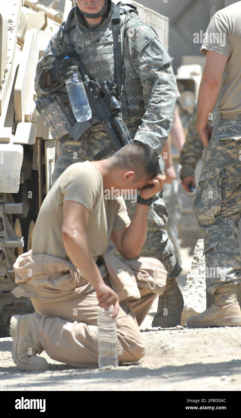 Sgt. First Class Tim Ybay from Long Beach, Calif., with C Company, 1st  Battalion, 26th Infantry Regiment, kneels and reflects after returning to  forward operating base Apache in eastern Baghdad after an