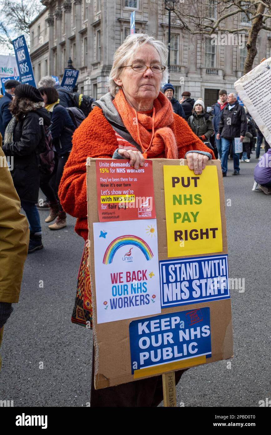 Women Protester with Protest Banner on NHS March culminating in Whitehall, London, 11th March, 2023. Support NHS demonstration, England, UK. Activism. Stock Photo