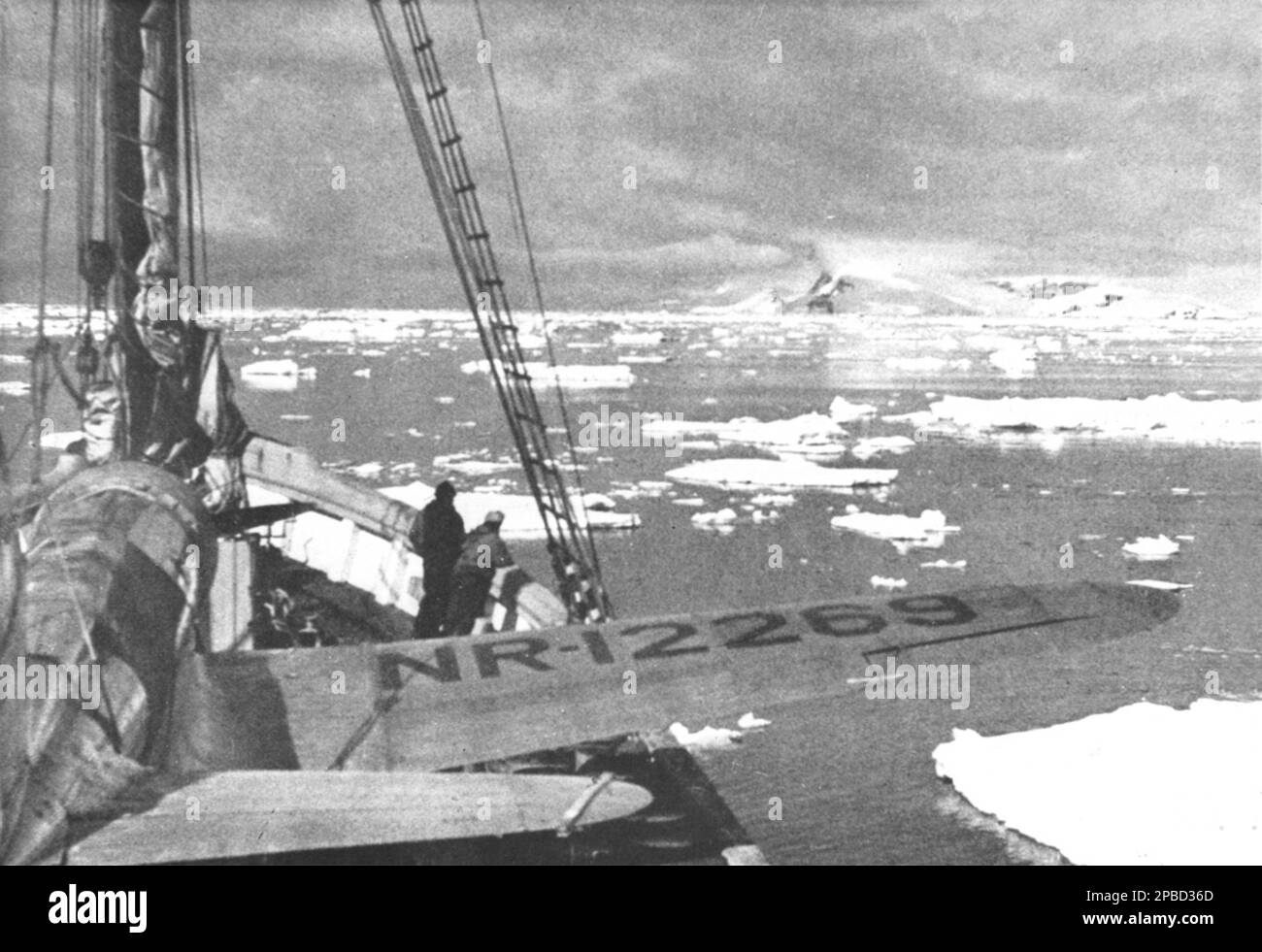 Polar star is seen in the bow of HMAS Wyatt Earp as the vessel's crew searches for a take-off field along the Antarctic Archipelego, 1948. Note the single-engine Vought-Sikorsky Kingfisher floatplane on deck. Stock Photo