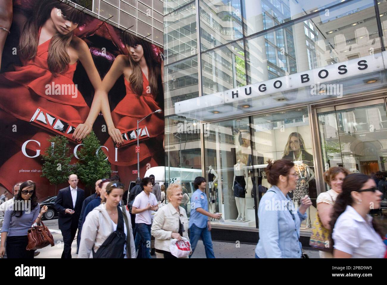 ADVANCE FOR FRIDAY JUNE 15 Shoppers stroll pass Gucci and Hugo Boss stores on Fifth Ave. Monday May 21 2007 in New York. It s no secret that luxury sales have been booming