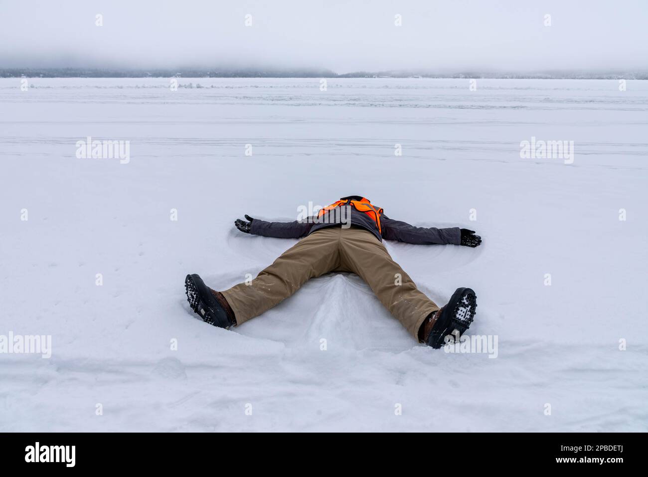 The making of a snow angel on Gunflint Lake in Northern Minnesota on the Canadian Border edge of the Boundary Water Canoe Area Wilderness frozen lake Stock Photo