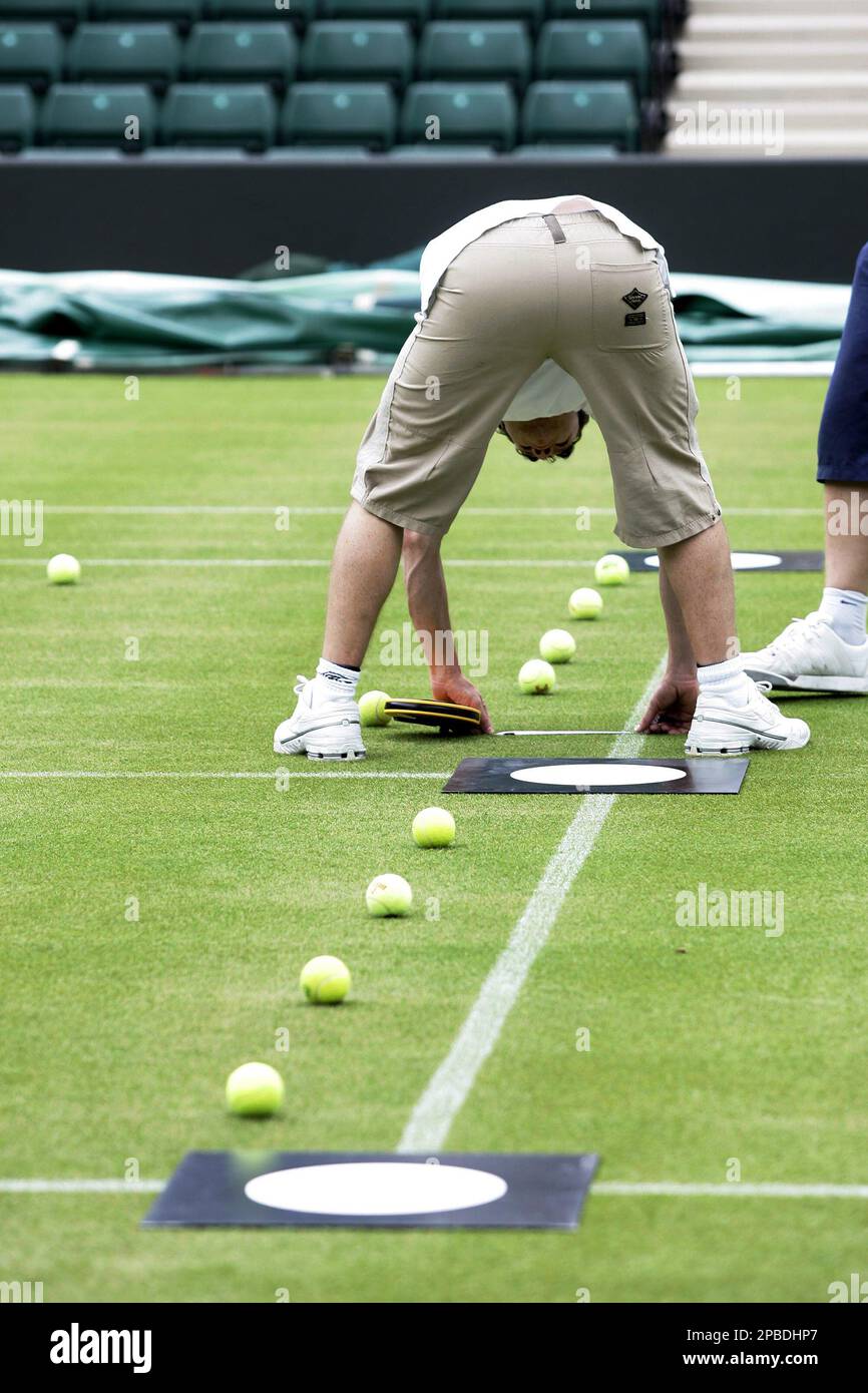Technicians prepare the tennis court for calibration of Hawk-Eye video line call system on Number One Court at Wimbledon All England Tennis Club, London, Friday, June 15, 2007