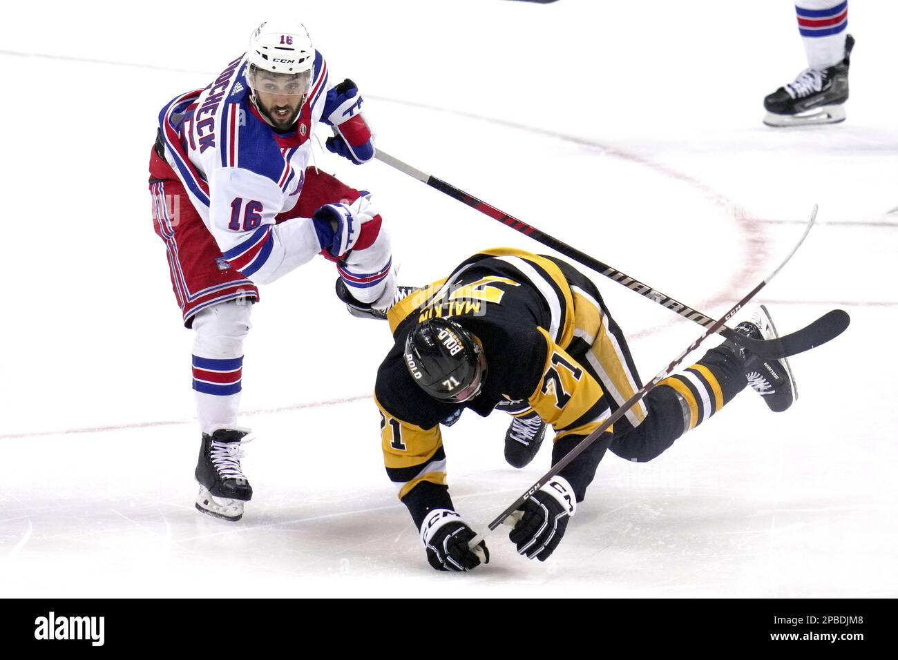 New York Rangers' Vincent Trocheck (16) checks Evgeni Malkin (71) to