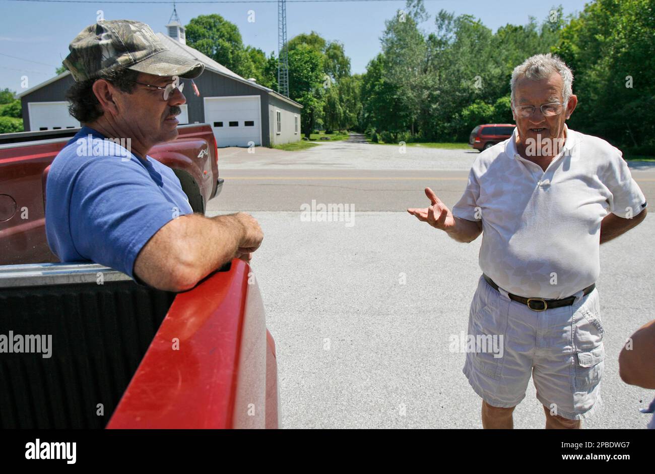 Selectboard chairman James Senesac Jr., left, and former selectboard member Chet Bromley talk