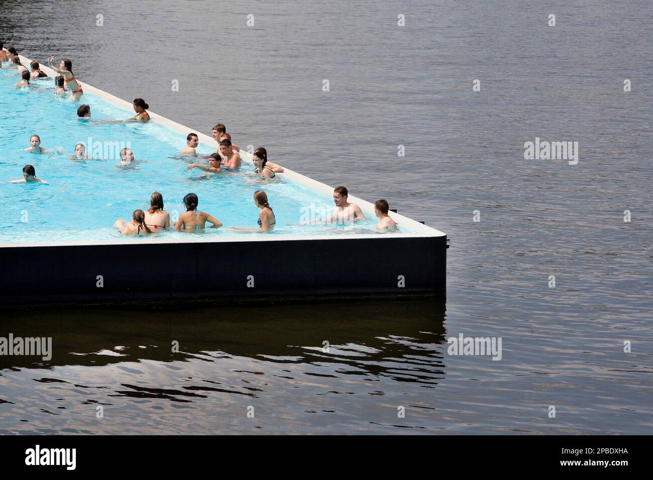 People relax in an outdoor swimming pool set into the River Spree in  Berlin, Tuesday, June 12, 2007. Many people used the temperatures around 31 degrees  Celsius (87 degrees Fahrenheit) to cool