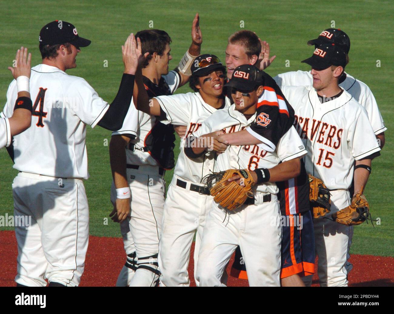 Oregon State players including Darwin Barney (6), Jonathan Casey, and Joey  Wong, left center, celebrate their 8-2 win against Michigan in the NCAA  Super Regional baseball playoff in Corvallis, Ore., Monday June