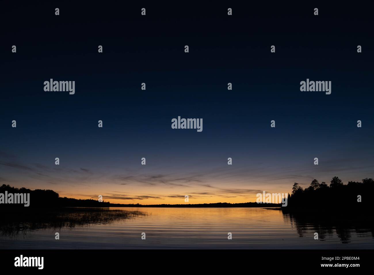 Fading sunset glow at dusk over northern lake scene for magazine ...