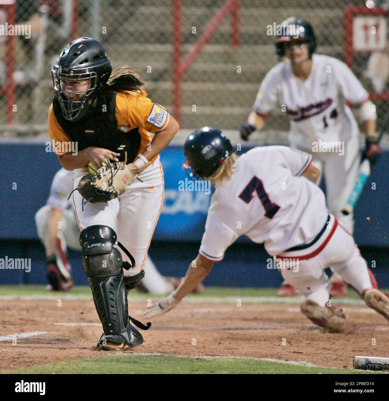 Tennessee catcher Shannon Doepking, left, gets the ball as Arizona's K'Lee  Arredondo, right, slides into home plate to score in the fifth inning of  the decisive third game of the NCAA women's