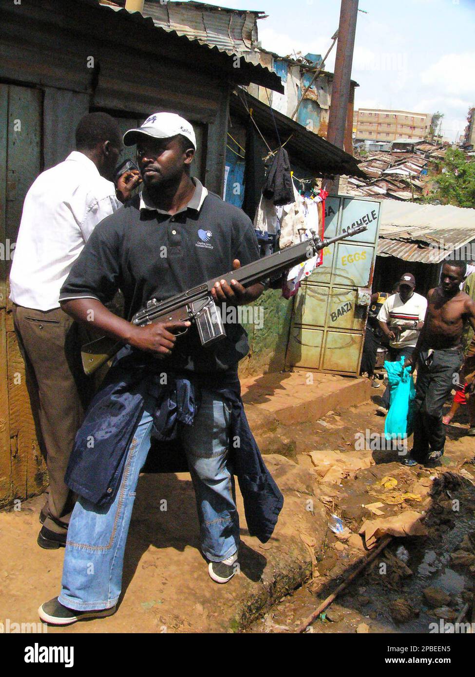 A plain clothed Kenyan policeman carries an automatic weapon as he ...