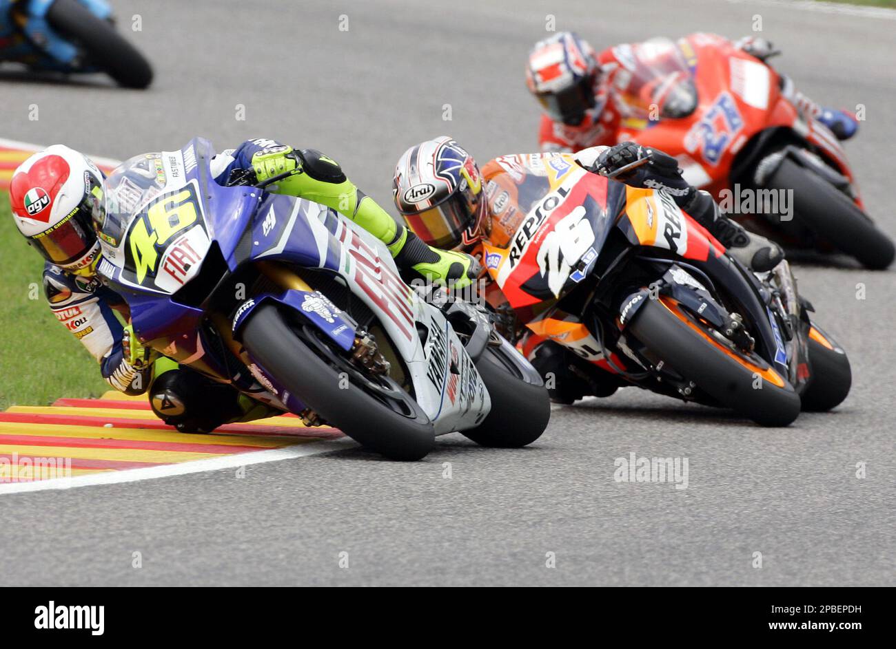 Yamaha driver Valentino Rossi, left, of Italy, pursued by Honda's Dani  Pedrosa n. 26 of Spain, and Ducati's Casey Stoner n. 27 of Australia,  during the Italian MotoGP, at the Mugello circuit,