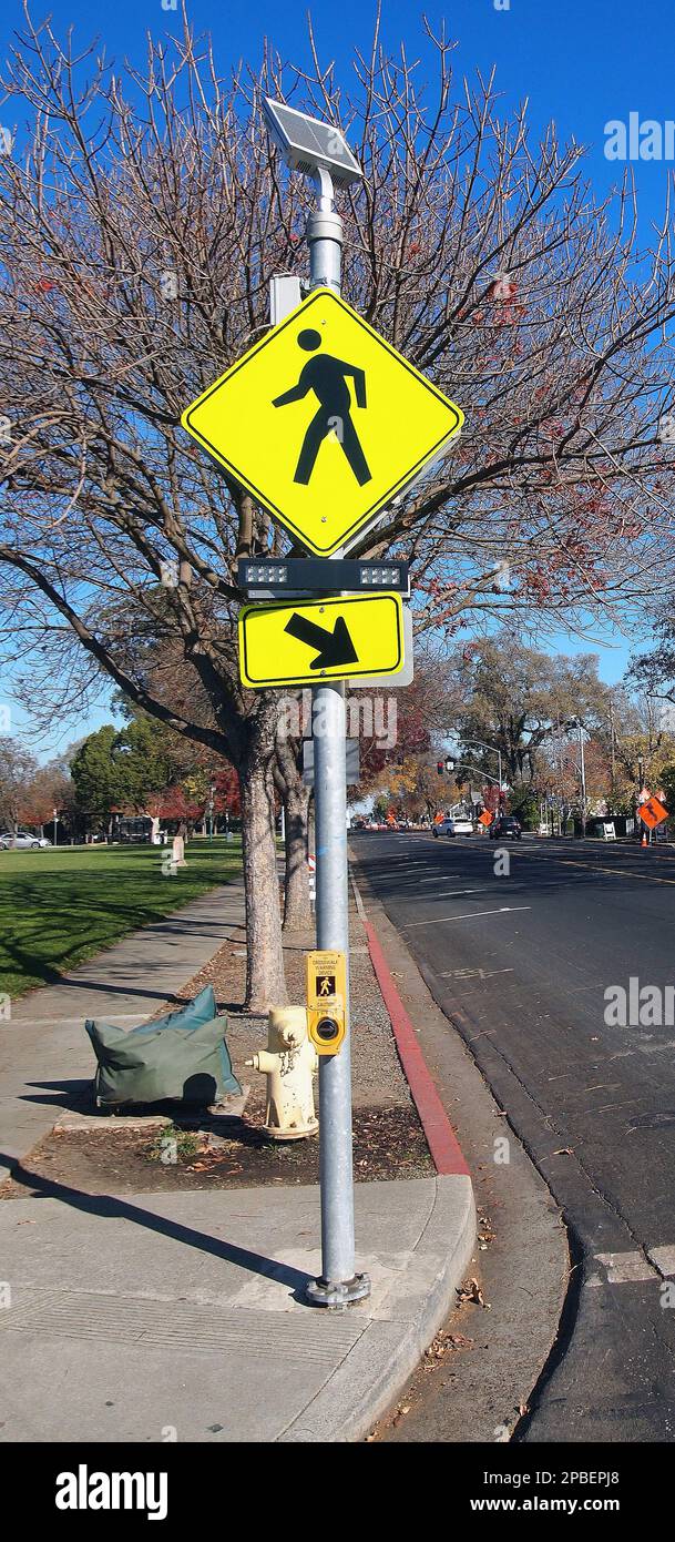 pedestrian cross walk sign  and solar panel powered lights in California Stock Photo