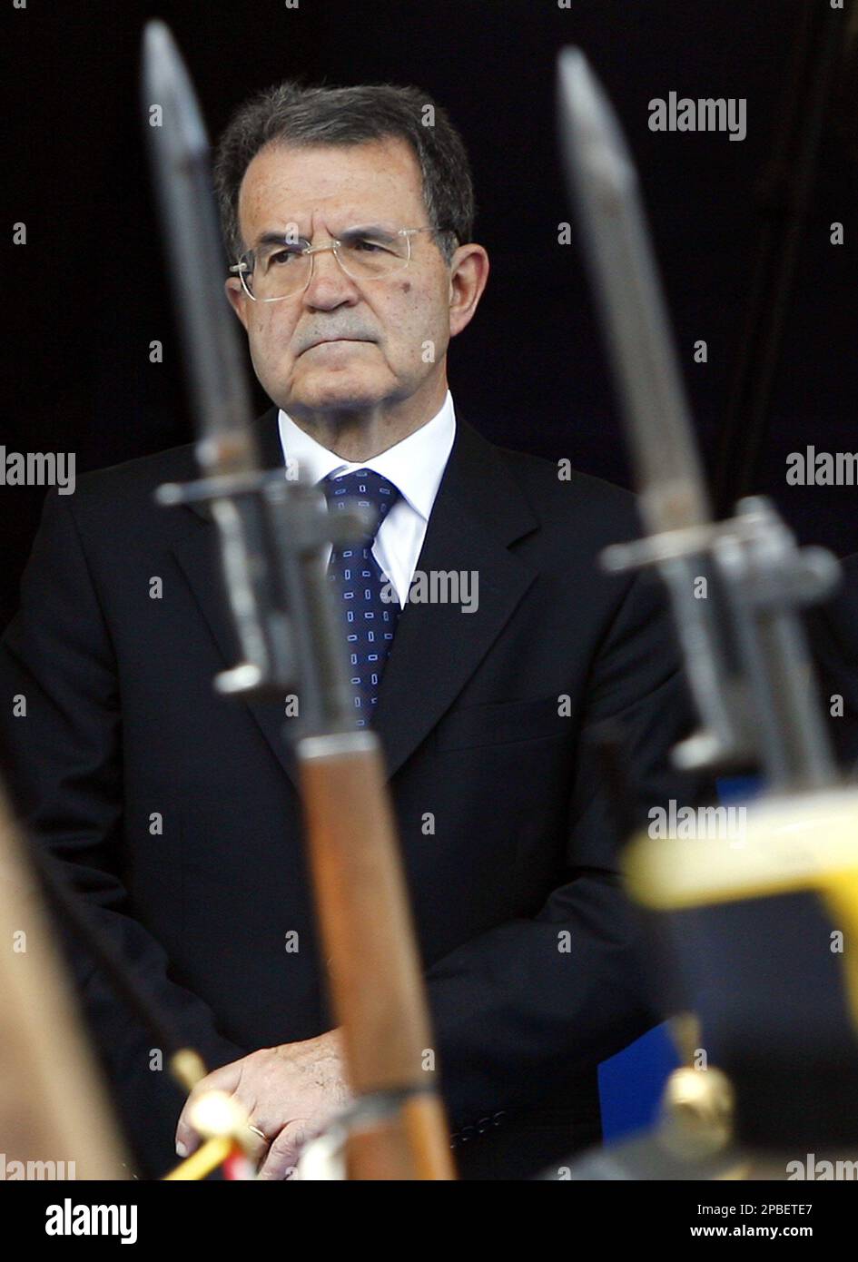 Italian Premier Romano Prodi looks on as soldiers carry rifles with ...