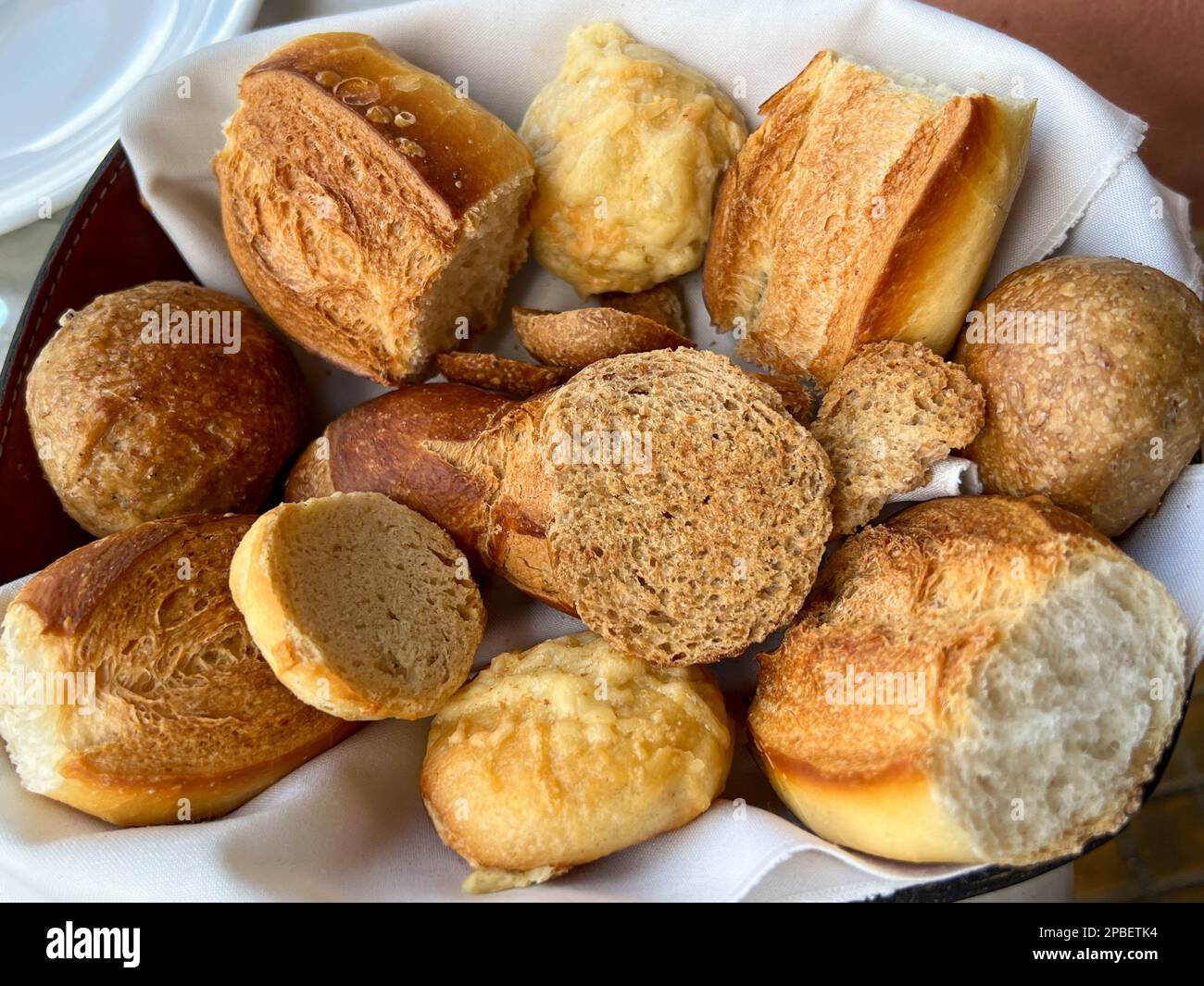 Basket of Argentine breads at urban restaurant welcomes travelers to a hearty meal Stock Photo