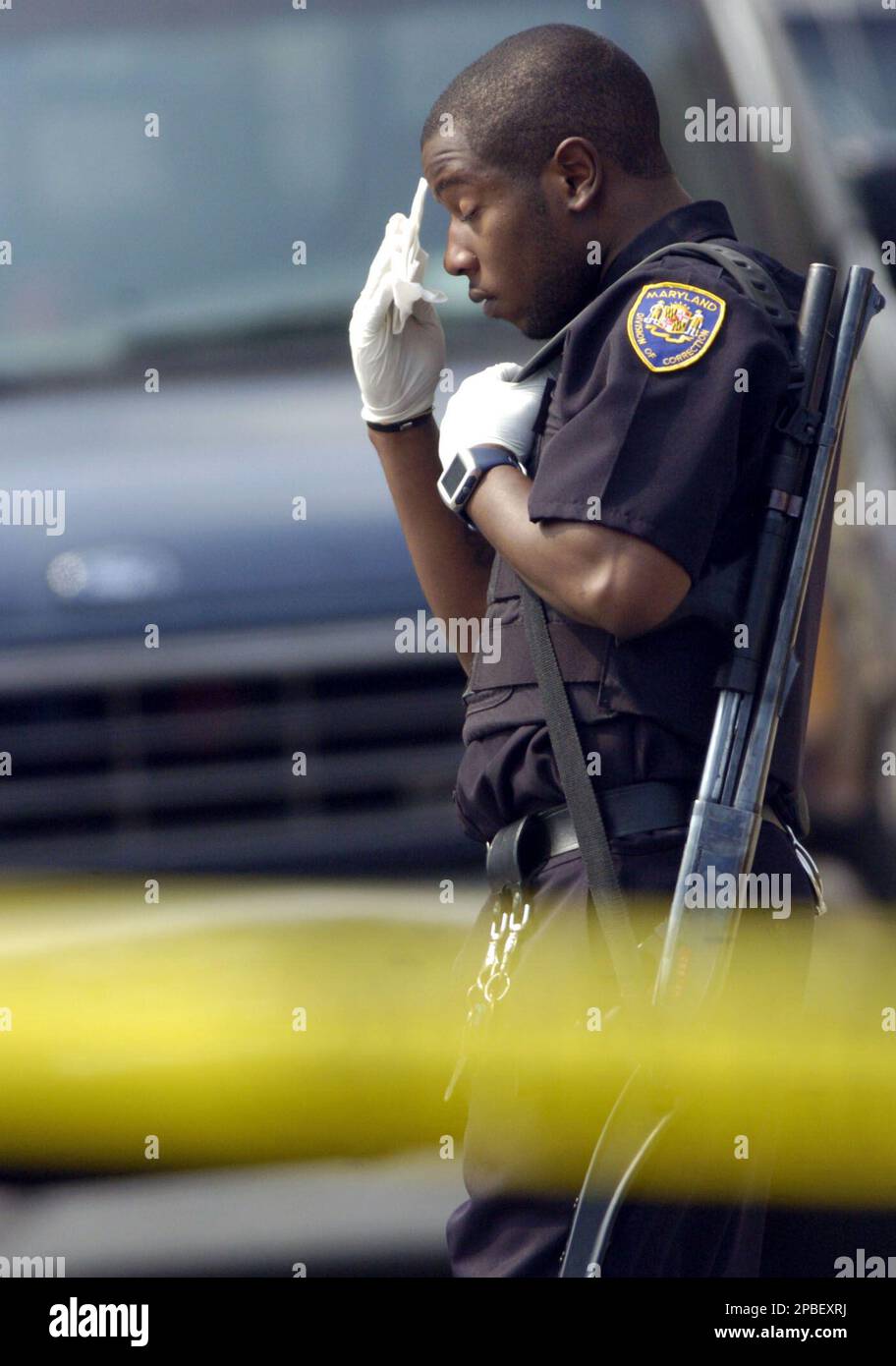 https://c8.alamy.com/comp/2PBEXRJ/a-maryland-department-of-corrections-officer-wipes-sweat-from-his-brow-while-standing-guard-outside-the-metropolitan-transition-center-hospital-after-as-many-as-15-people-were-stabbed-some-of-them-seriously-when-a-fight-broke-out-among-inmates-friday-june-1-2007-at-the-metropolitan-transition-center-correctional-facility-in-baltimore-ap-photosteve-ruark-2PBEXRJ.jpg