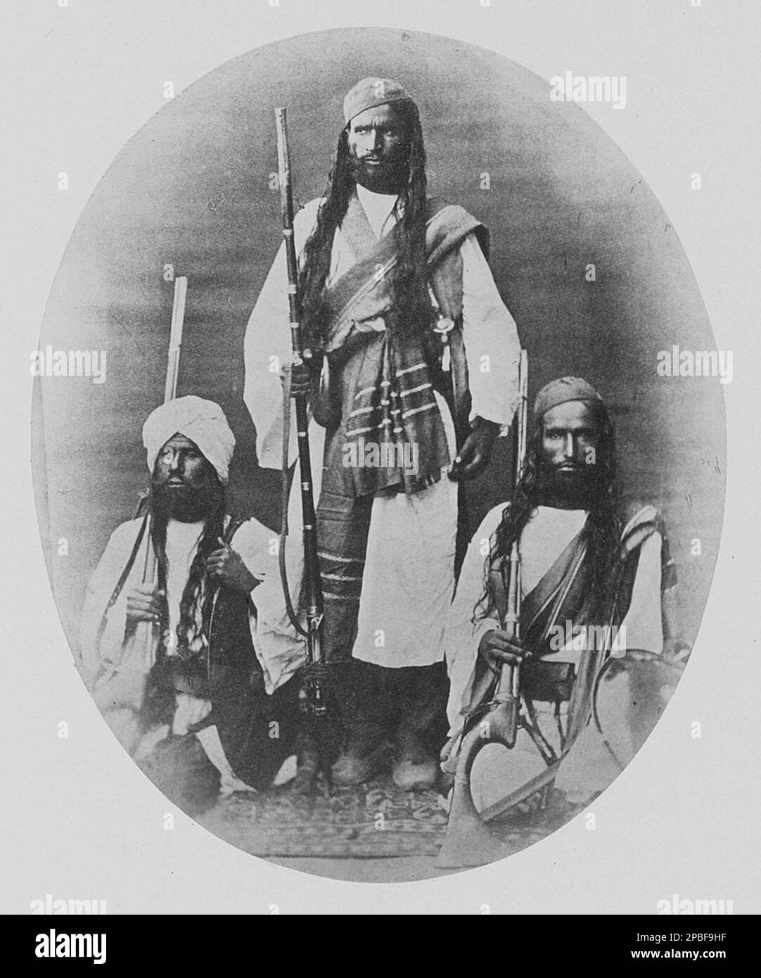 Portrait of three unknown men of Brahui descent Stock Photo