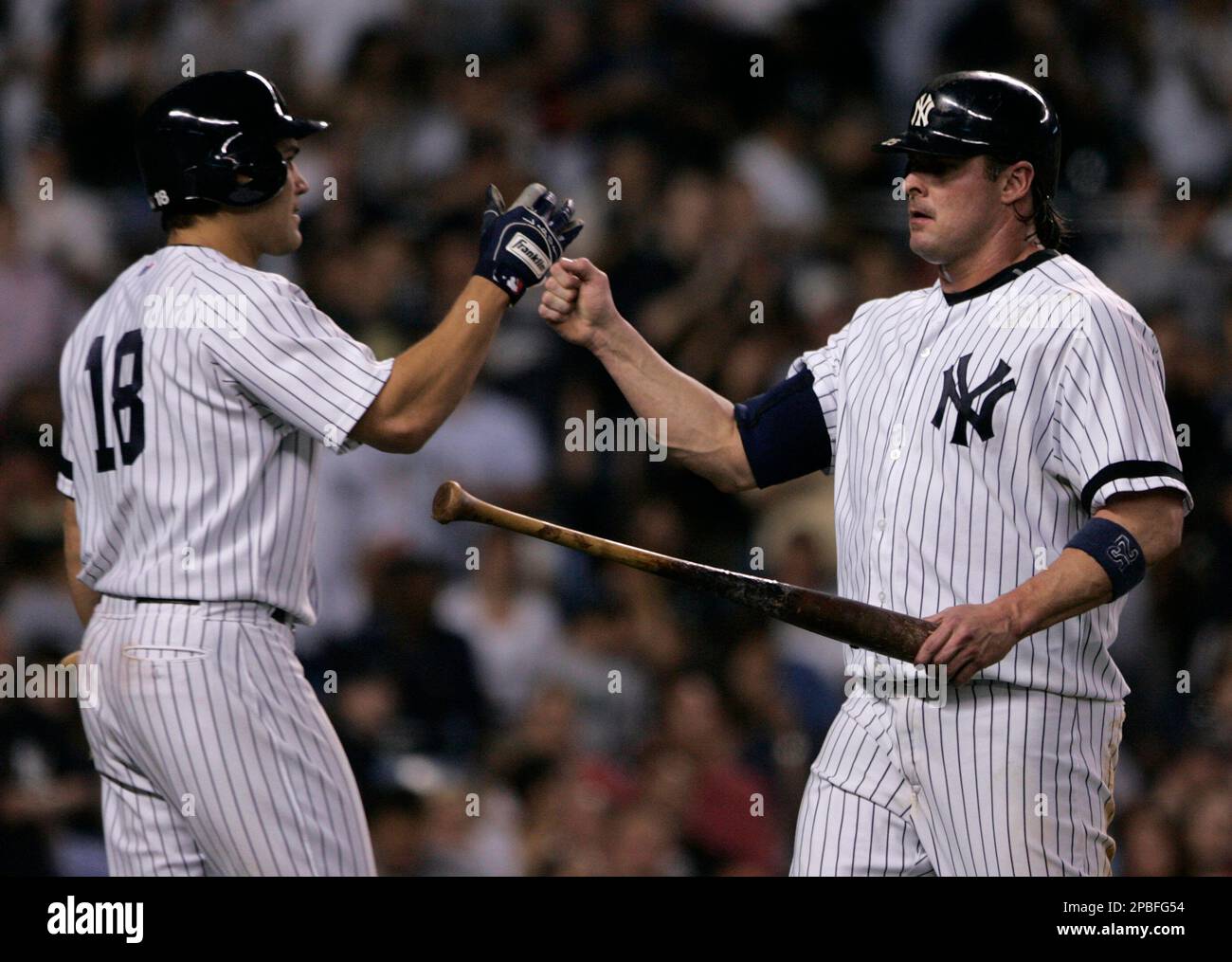 New York Yankees' Jason Giambi, right, is greeted at home plate by Johnny  Damon after scoring on a single by Doug Mientkiewicz during the fourth  inning in Major League Baseball action Friday