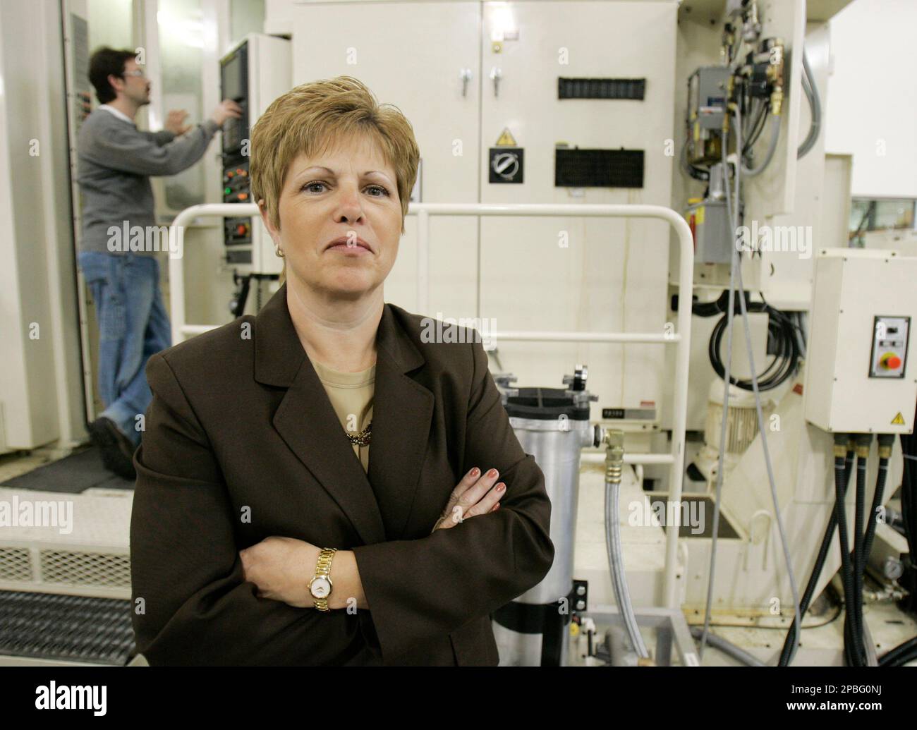 Mary Pat Salomone, president and CEO of Marine Mechanical, poses as Ray  Hill works on a CNC milling machine, Wednesday, April 11, 2007, in Euclid,  Ohio. The nation has shed five million