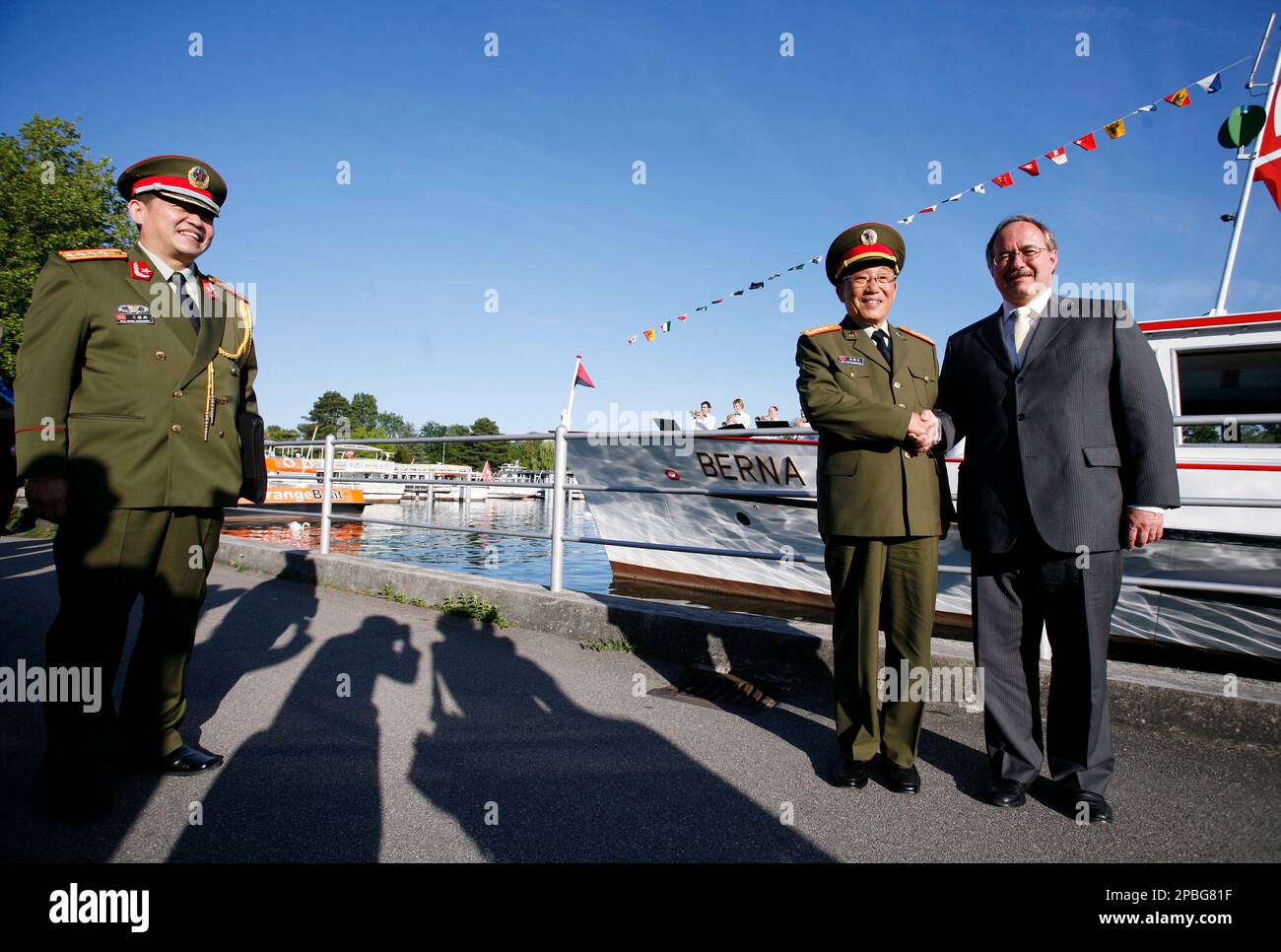 Chinese defence minister Cao Gangchuan, center, and his Swiss counterpart  Samuel Schmid, right, pose prior to a boat tour on the lake of Bienne,  Saturday, May 19, 2007, in Bienne, Switzerland; person