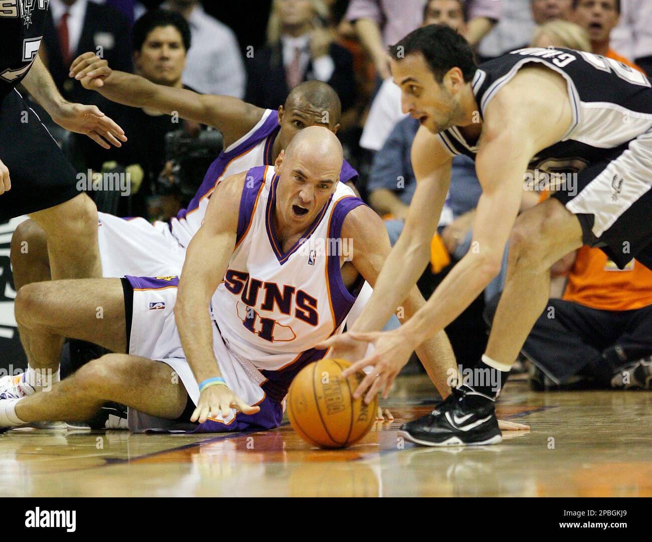 Phoenix Suns' Pat Burke, left, of Ireland, comes in late for a loose ball  as San Antonio Spurs' Manu Ginobili, of Argentina, grabs the ball in the  first quarter of a Western