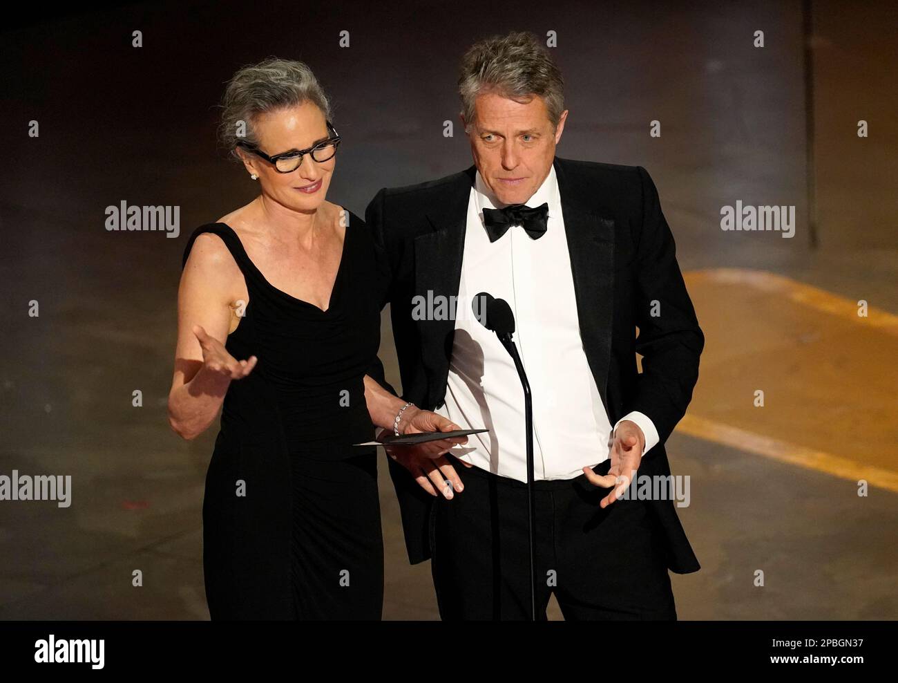Andie MacDowell, left, and Hugh Grant present the award for best