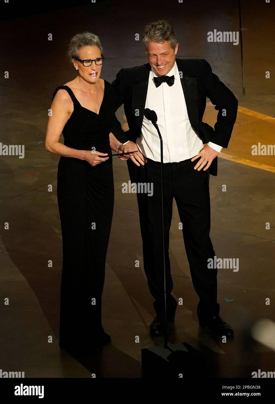 Andie MacDowell, left, and Hugh Grant present the award for best