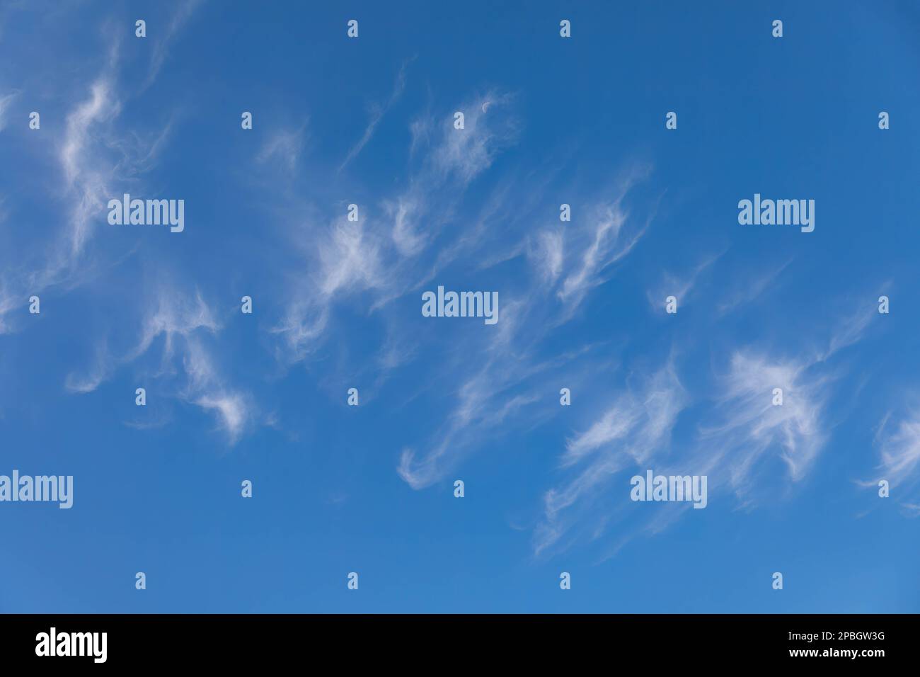 Clouds and moon against a beautiful blue sky Stock Photo