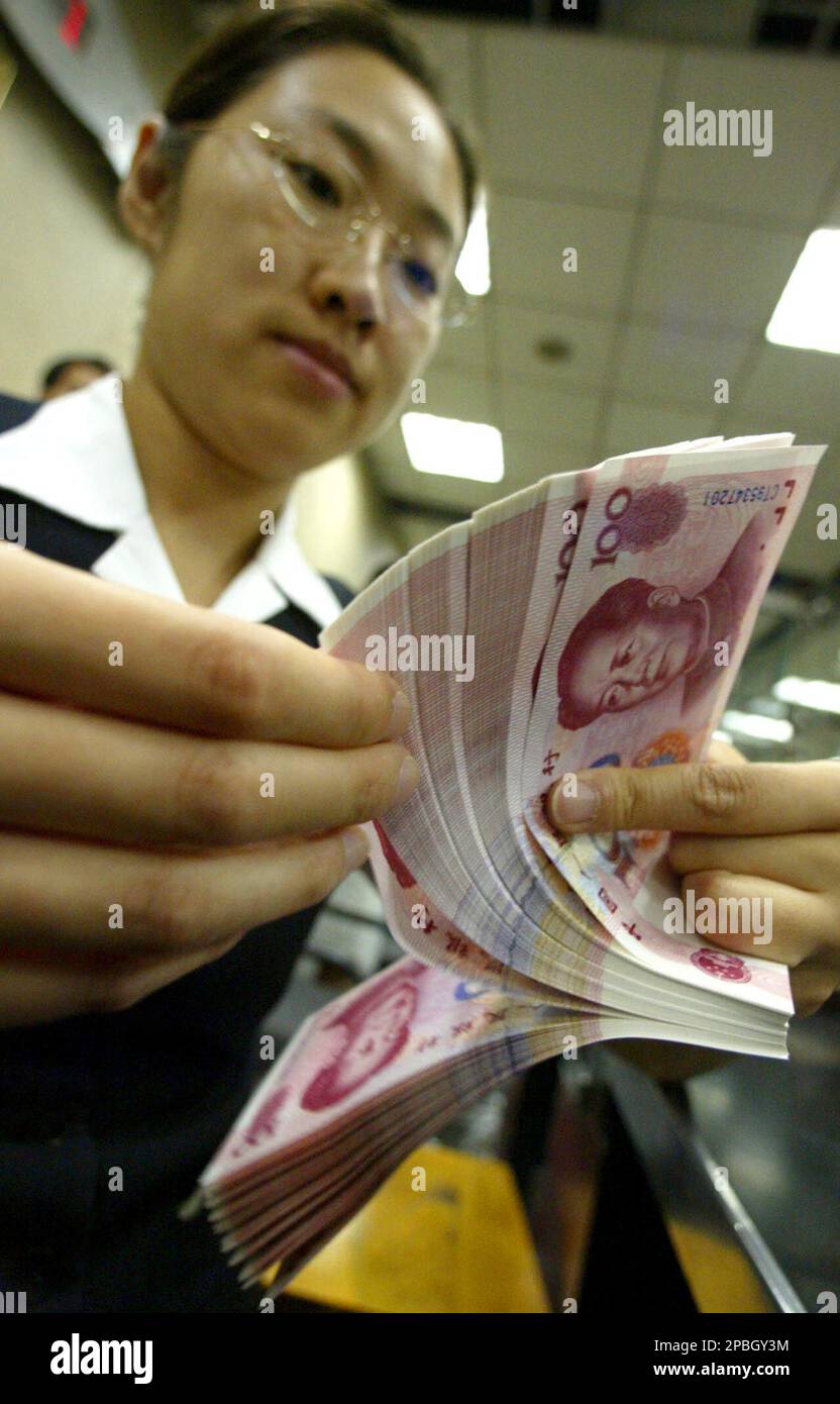 FILE ** A Bank of China employee counts Chinese 100 Yuan notes at a branch  outlet in Beijing, China, in this Thursday, July 3, 2003 file photo. Chinese  officials on Tuesday,