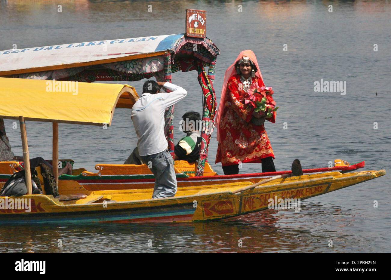 An Indian tourist wearing traditional Kashmiri dress poses for a