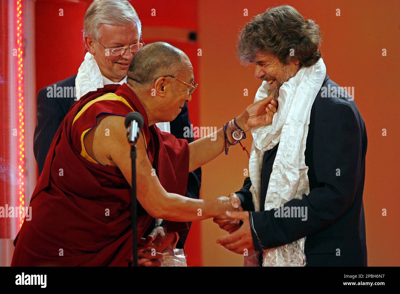 The Dalai Lama touches the beard of mountain climber Reinhold Messner,  right, at the reception of the 'Osgar' Media award in Leipzig, Germany,  Saturday, May 12, 2007. He was awarded for his