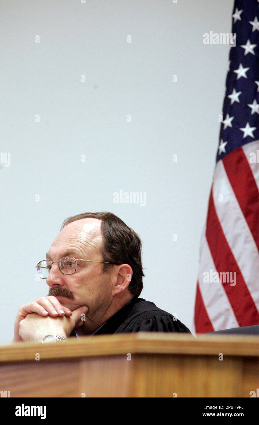 District Court Judge Michael Mullins listens to testimony in the trial
