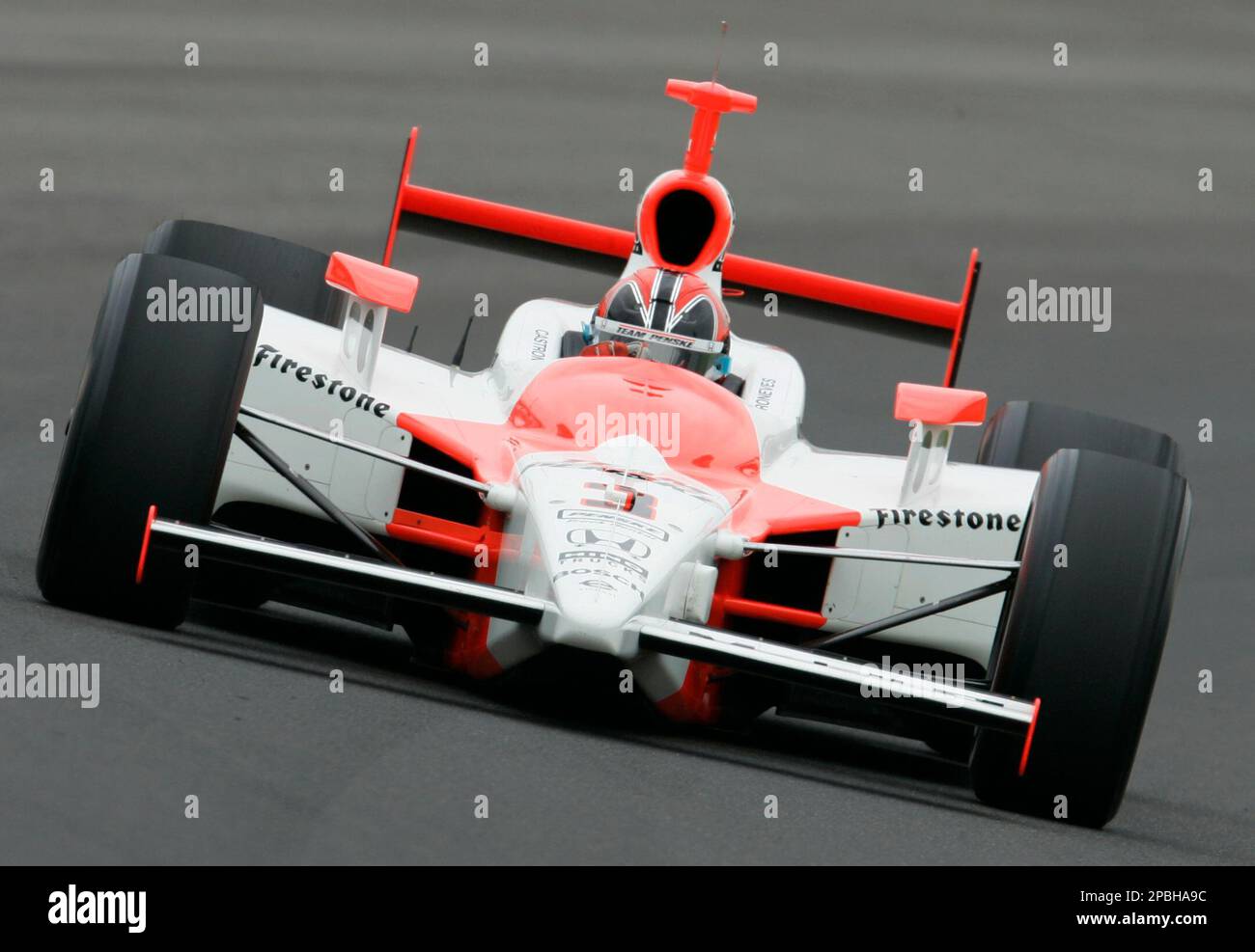 Race car driver Helio Castroneves of Brazil, speeds through the first