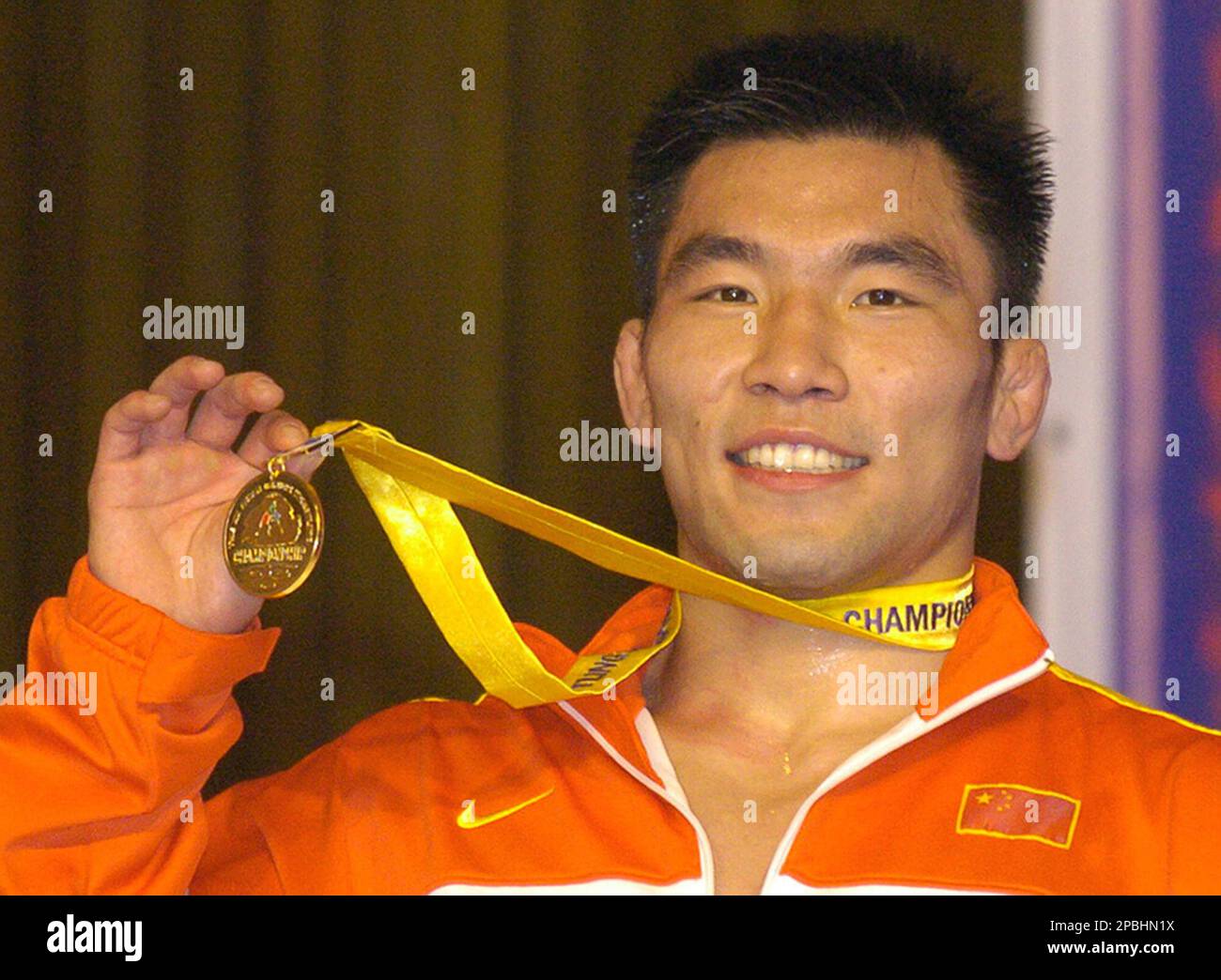 China's Wu Zijian shows his gold medal in the 74-kilogram class at the ...