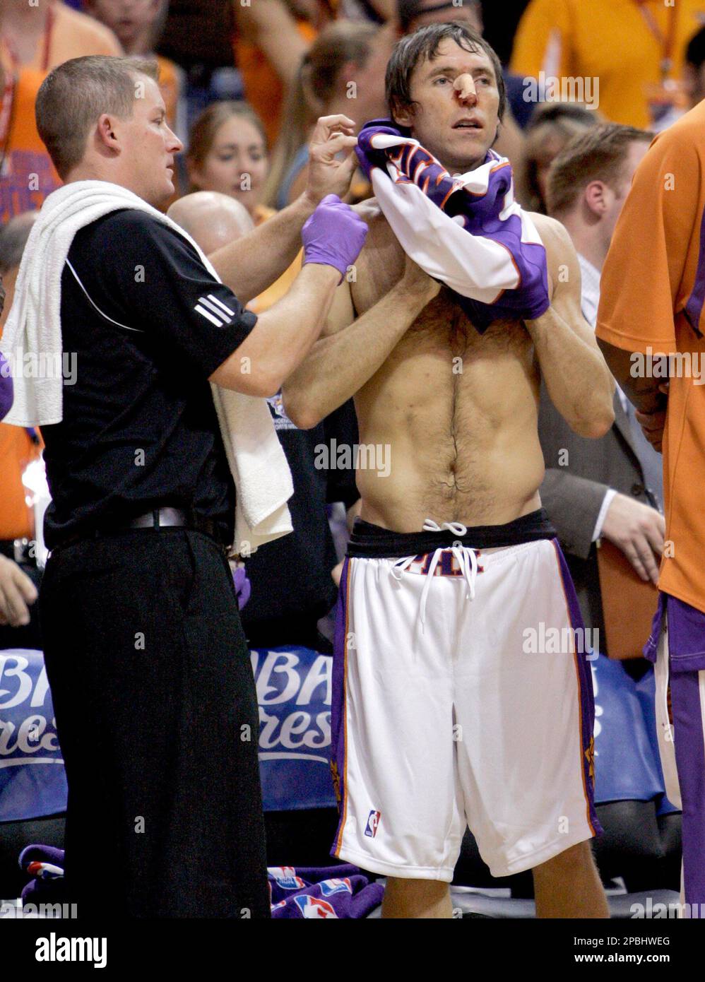 Phoenix Suns guard Steve Nash changes his bloodied jersey after cutting his  nose after running into San Antonio Spurs' Tony Parker during the fourth  quarter of an NBA Western Conference semifinal round