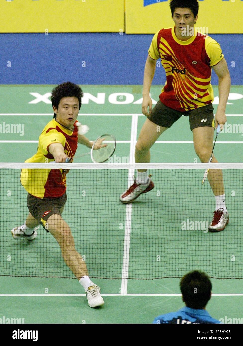 Chinas Yun Cai, left, return a shot as his partner Fu Haifeng looks on during their mens doubles finals of the Aviva Badminton Open Singapore Super-Series Sunday, May 6, 2007 in Singapore.