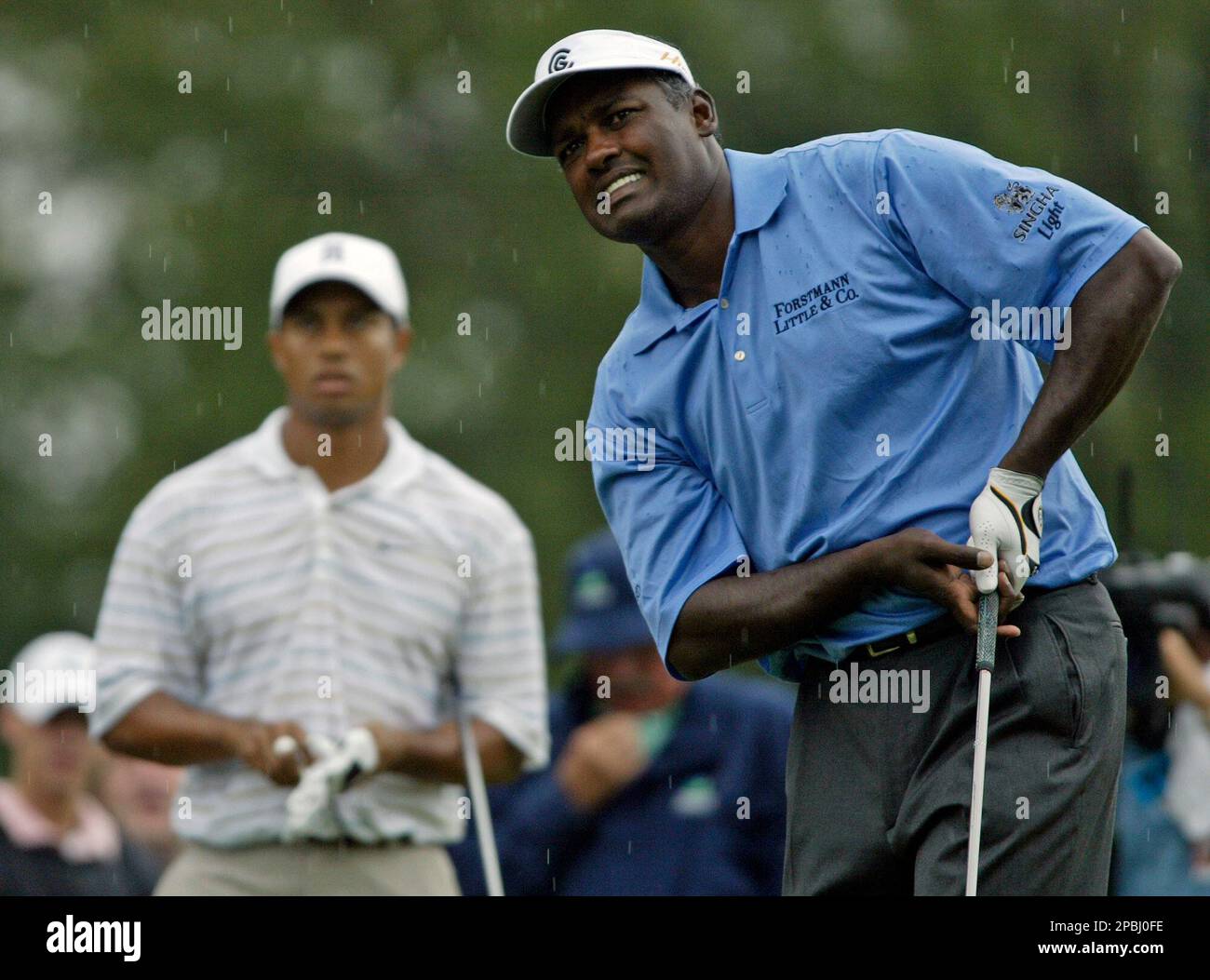 Vijay Singh of Fiji holds the championship trophy with Mickey