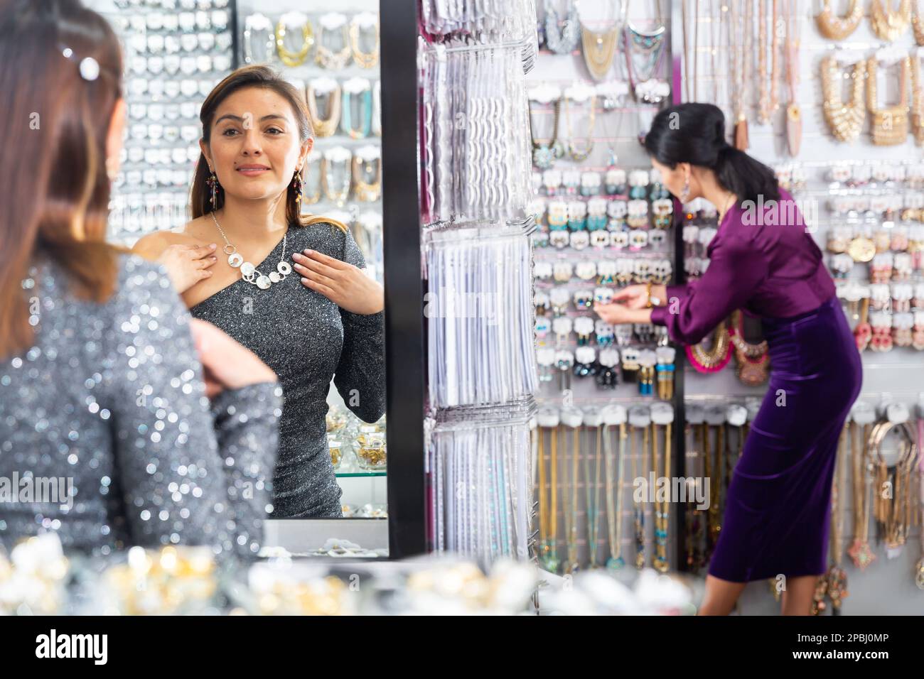 Woman trying on necklace in bijouterie shop Stock Photo