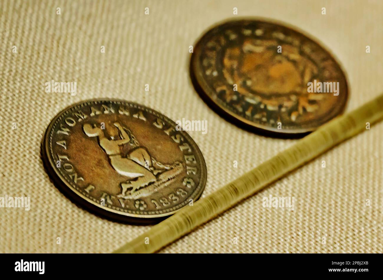Anti-slavery tokens circa 1838 are displayed at the “Spirits of the Passage: The Story of the Transatlantic Slave Trade” exhibit at GulfQuest Museum. Stock Photo