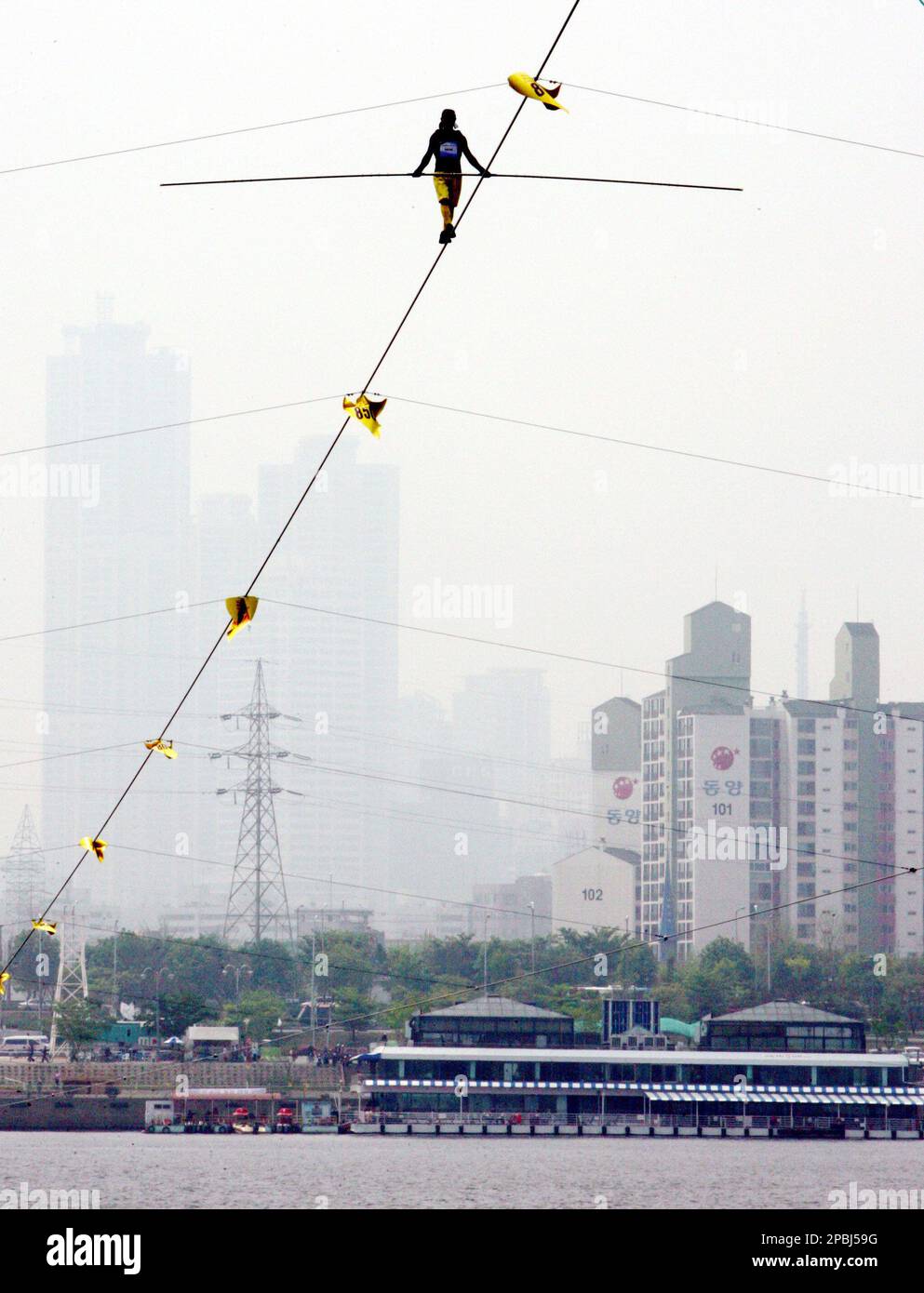Japan's Hayato Ouchi walks a high wire during the 1st World High Wire
