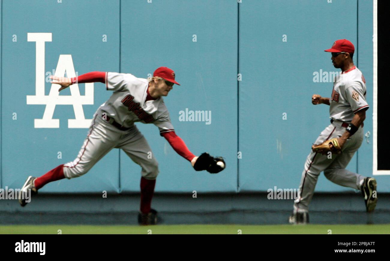 Colorado Rockies first baseman Todd Helton (L) celebrates after making the  final out against Arizona Diamondbacks left fielder Eric Byrnes during game  four of the National League Championship Series at Coors Field