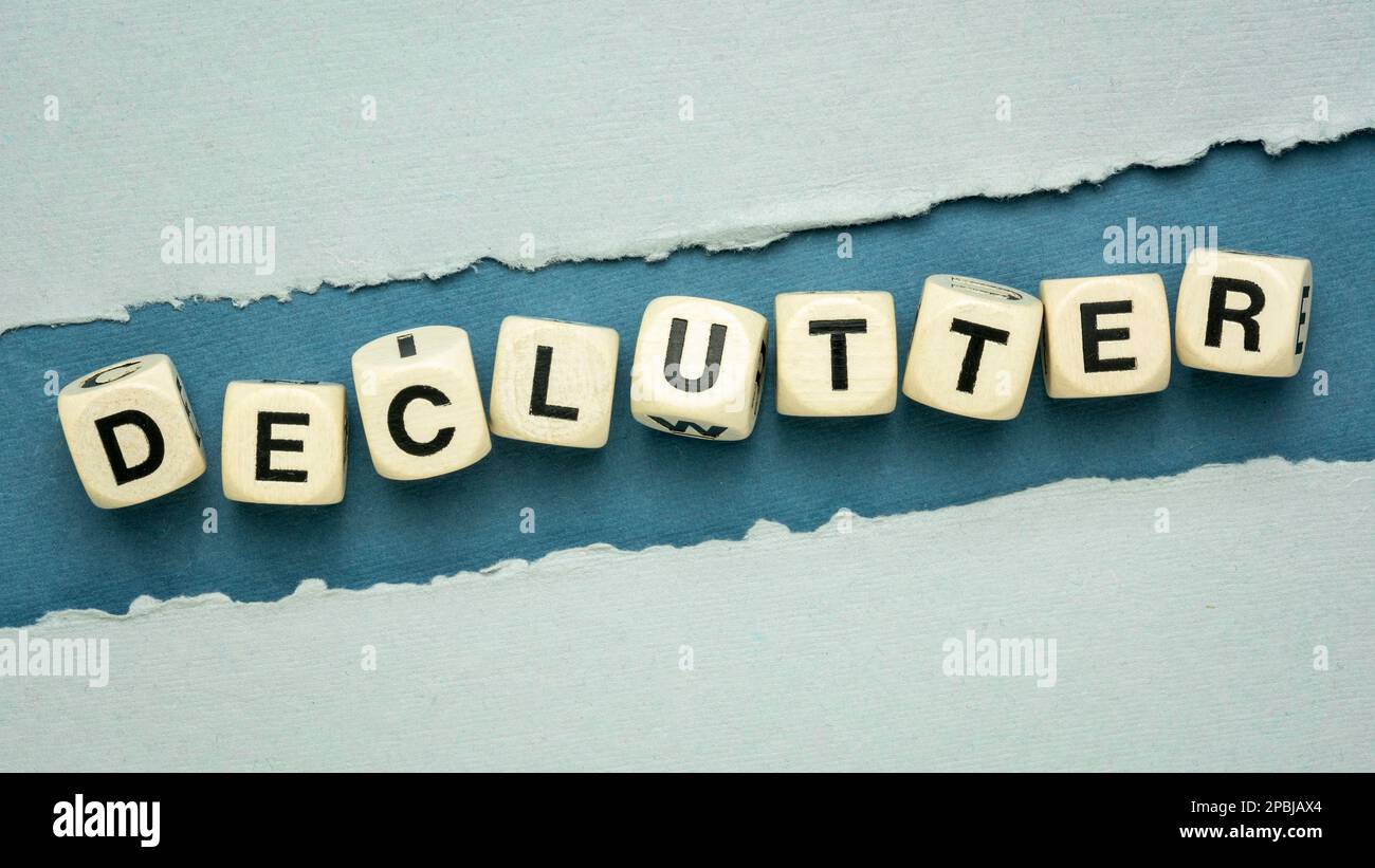 declutter word in wooden dice cubes on a handmade textured paper